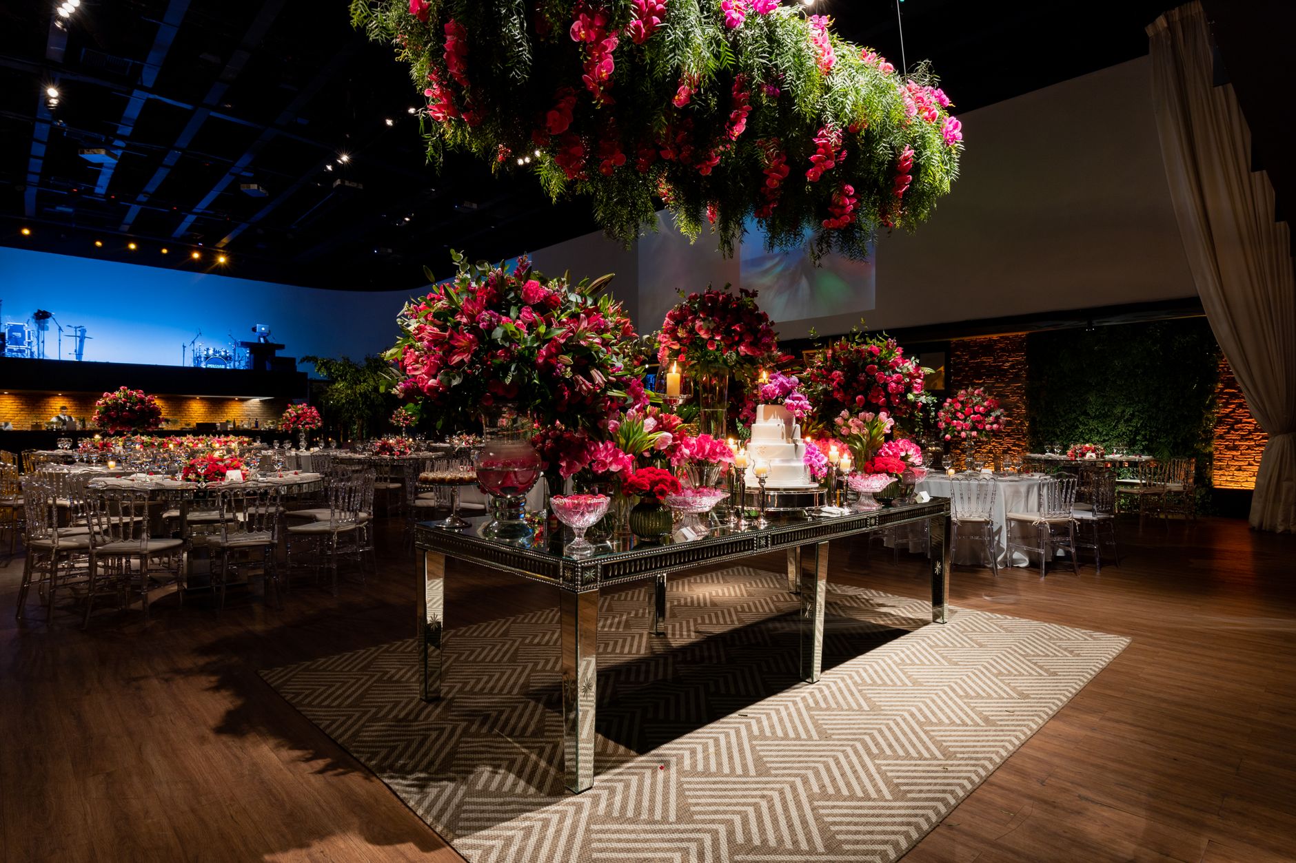 Wedding venue decorated with vibrant floral arrangements and elegant table settings under romantic lighting